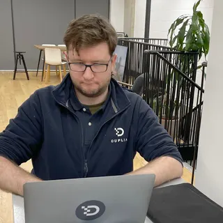 A Duplia engineer working on a laptop